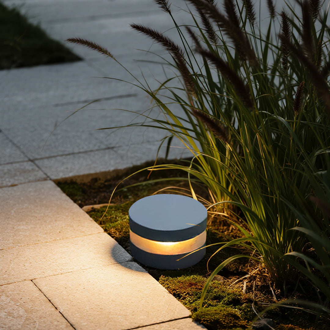 110v landscape lights positioned near ornamental grasses, creating a cozy and stylish outdoor night atmosphere.