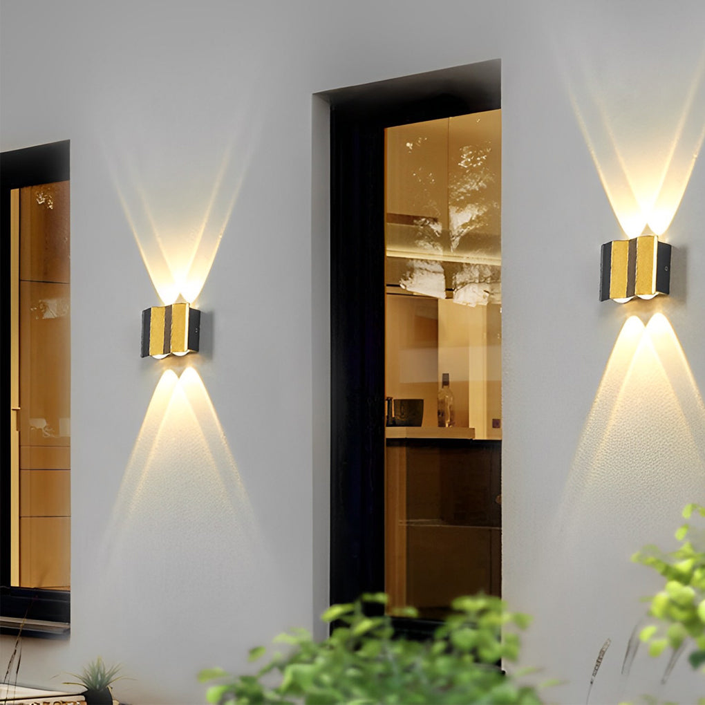 Wall sconce up-down light enhancing a minimalist outdoor space with sleek, ambient lighting.