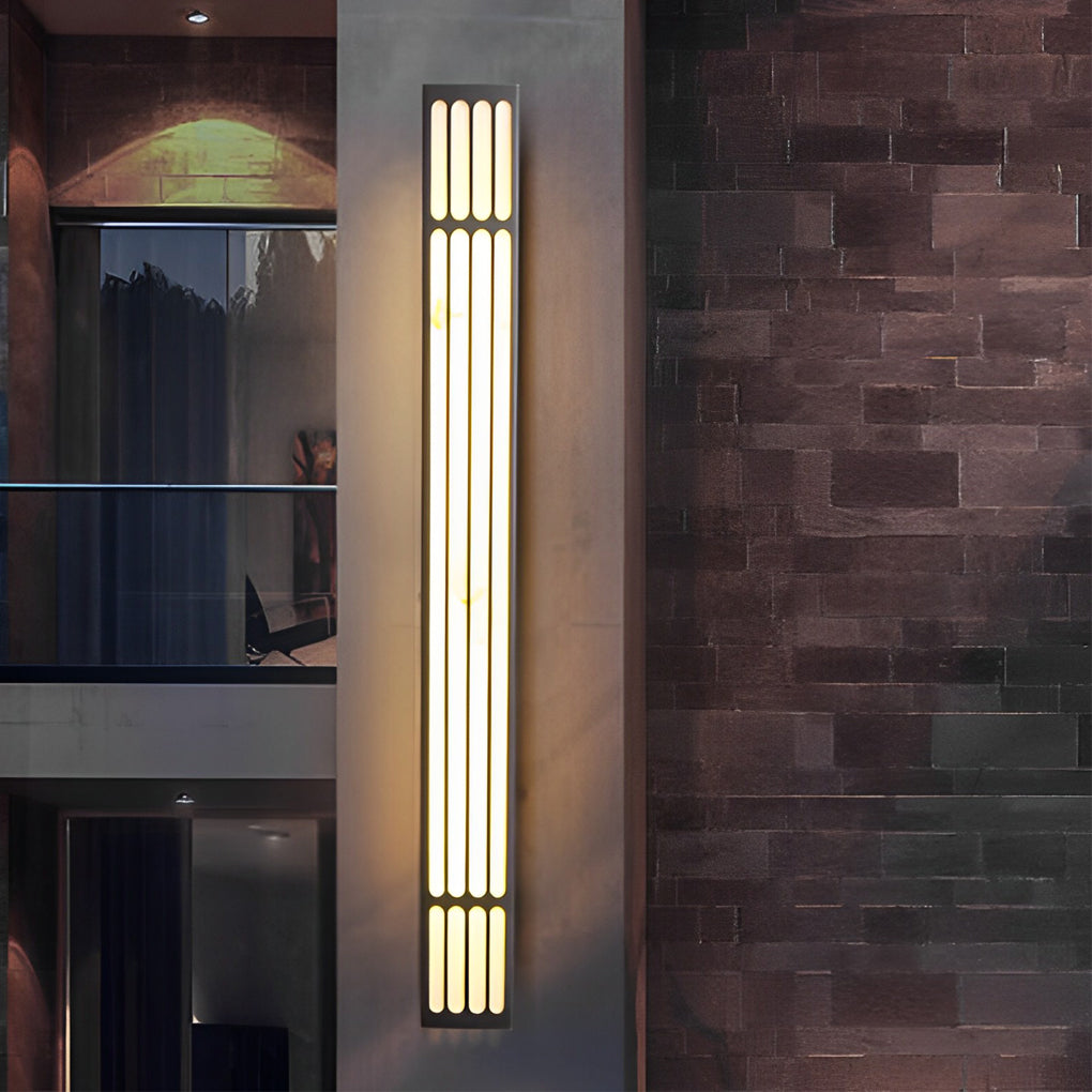 Large outdoor wall light enhancing a contemporary building facade with vertical lighting.