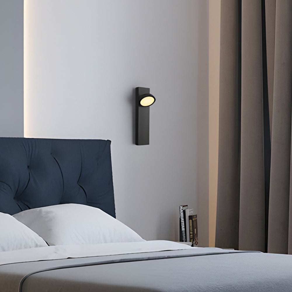Accent wall lamp placed above bed for subtle wall illumination.
