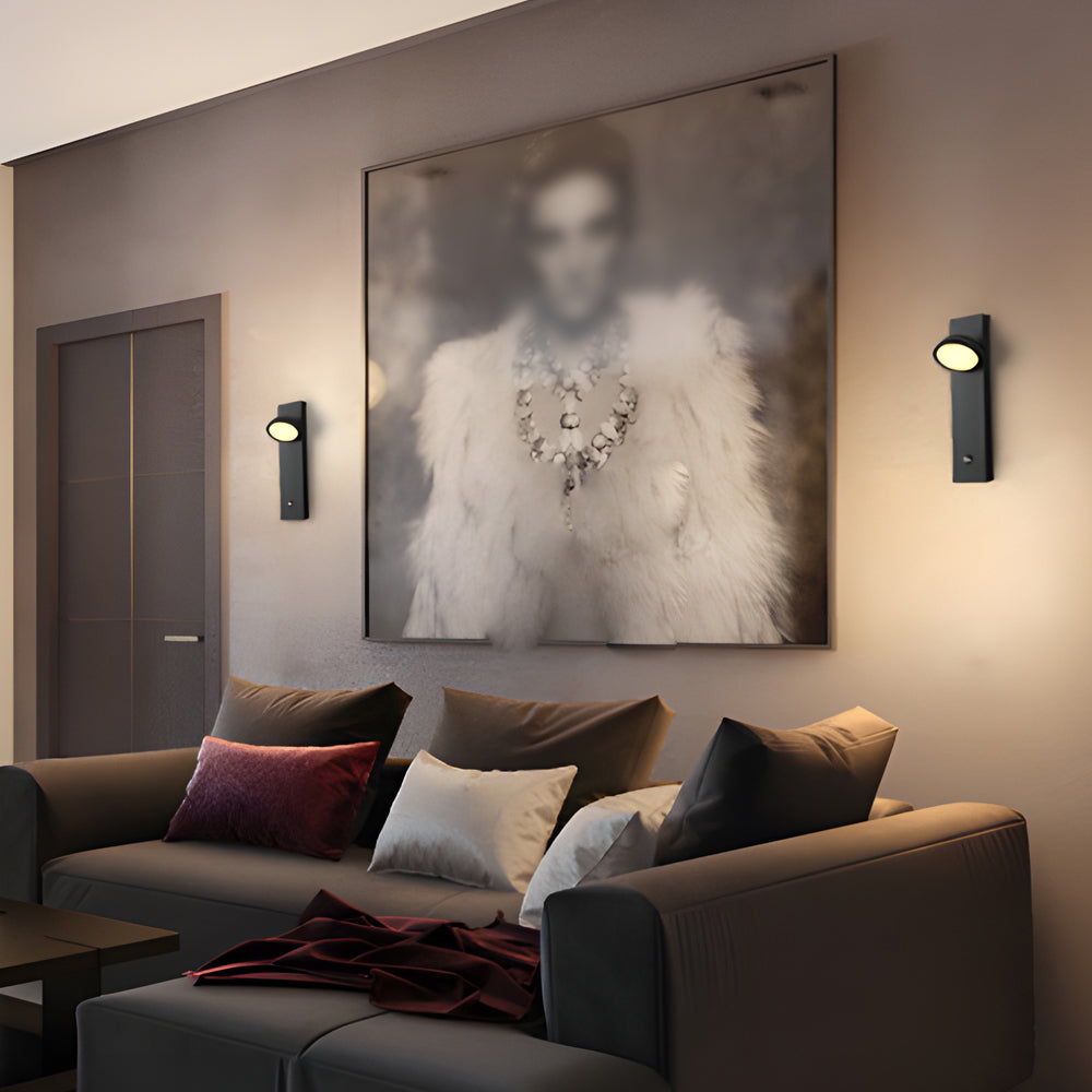 Accent wall lamp highlighting artwork in contemporary living room.