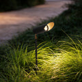 Adjustable landscape lighting illuminating a modern garden pathway with focused directional glow.