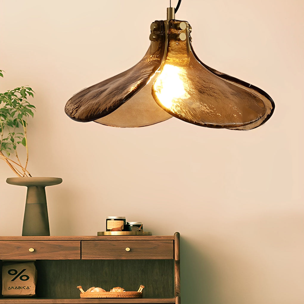Amber glass pendant light enhancing a contemporary bedroom with elegant, warm light.