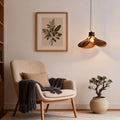 Amber glass pendant light illuminating a cozy reading nook with warm, inviting glow.
