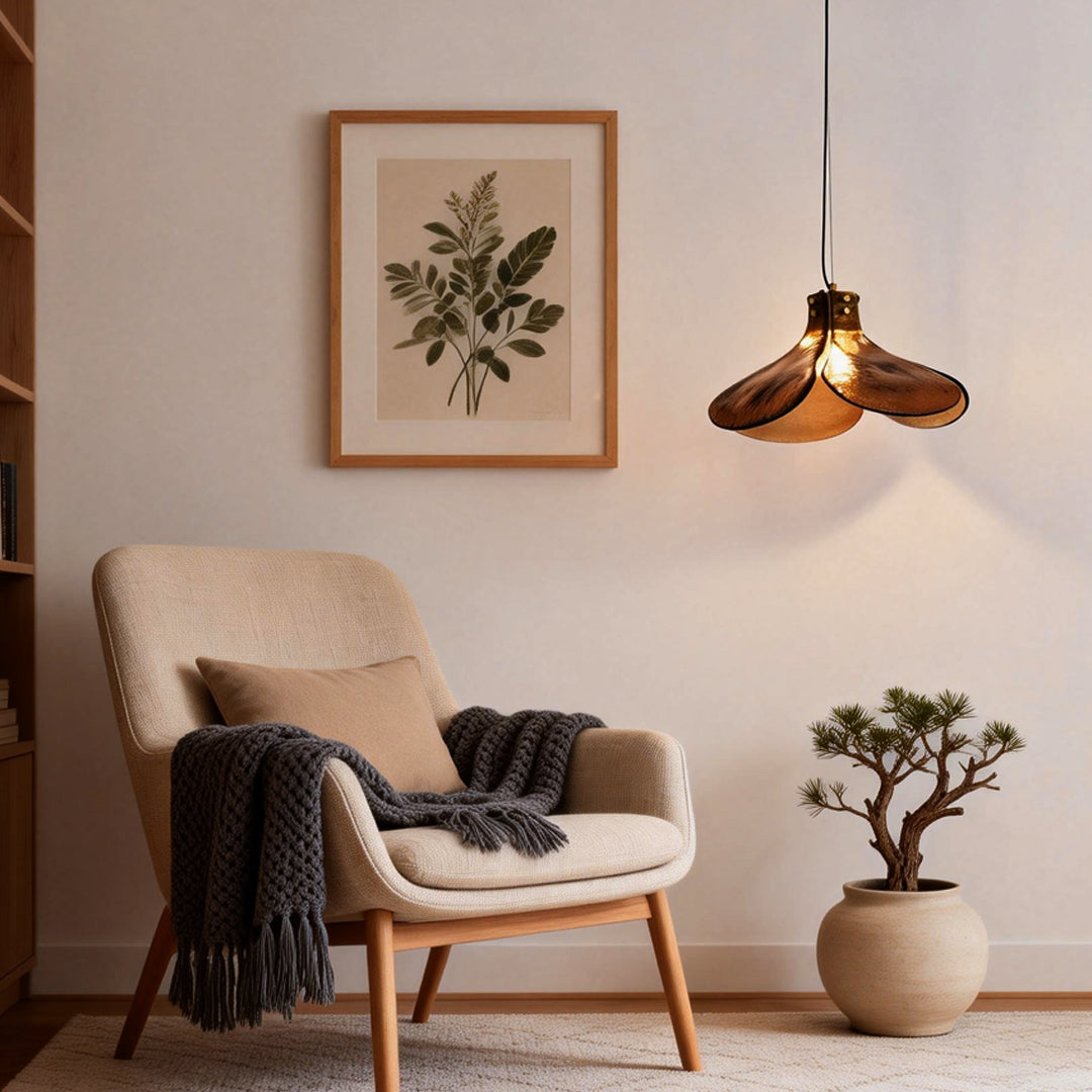 Amber glass pendant light illuminating a cozy reading nook with warm, inviting glow.