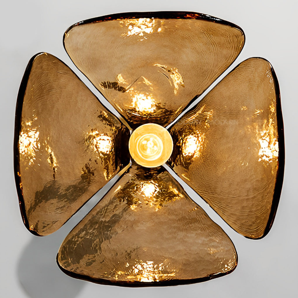 Amber glass pendant light enhancing a minimalist bedroom with warm, golden glow.