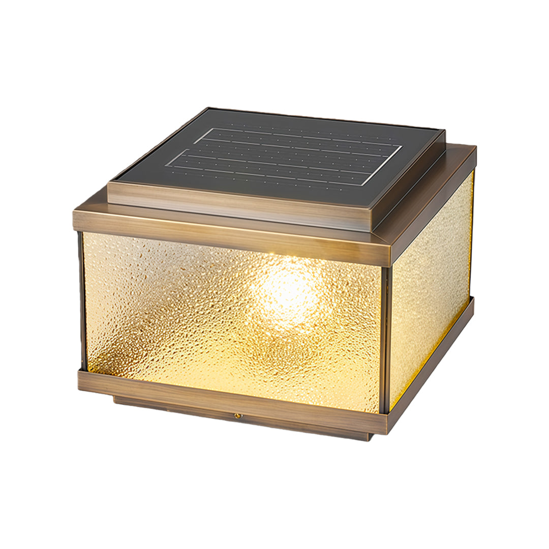 Square garden pillar light with warm amber glow and bubble-textured glass on dark solar panel top.