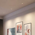 Angled adjustable spotlights featuring white bezel and glass shade chandelier inspired black reflector cone.