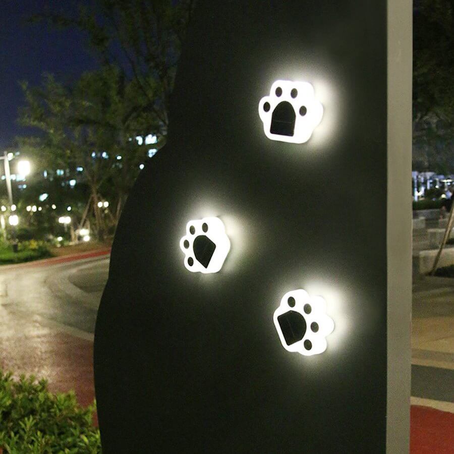 Animal paw step stairs light with a close-up of three paw-shaped lights glowing.