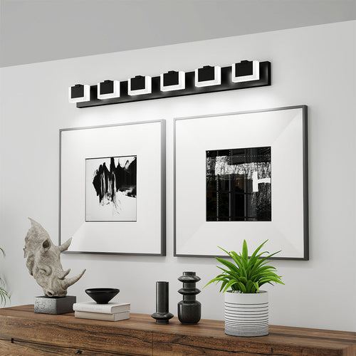 Architectural bathroom LED vanity lights with glass shade chandelier styling creating gallery atmosphere with framed artwork.
