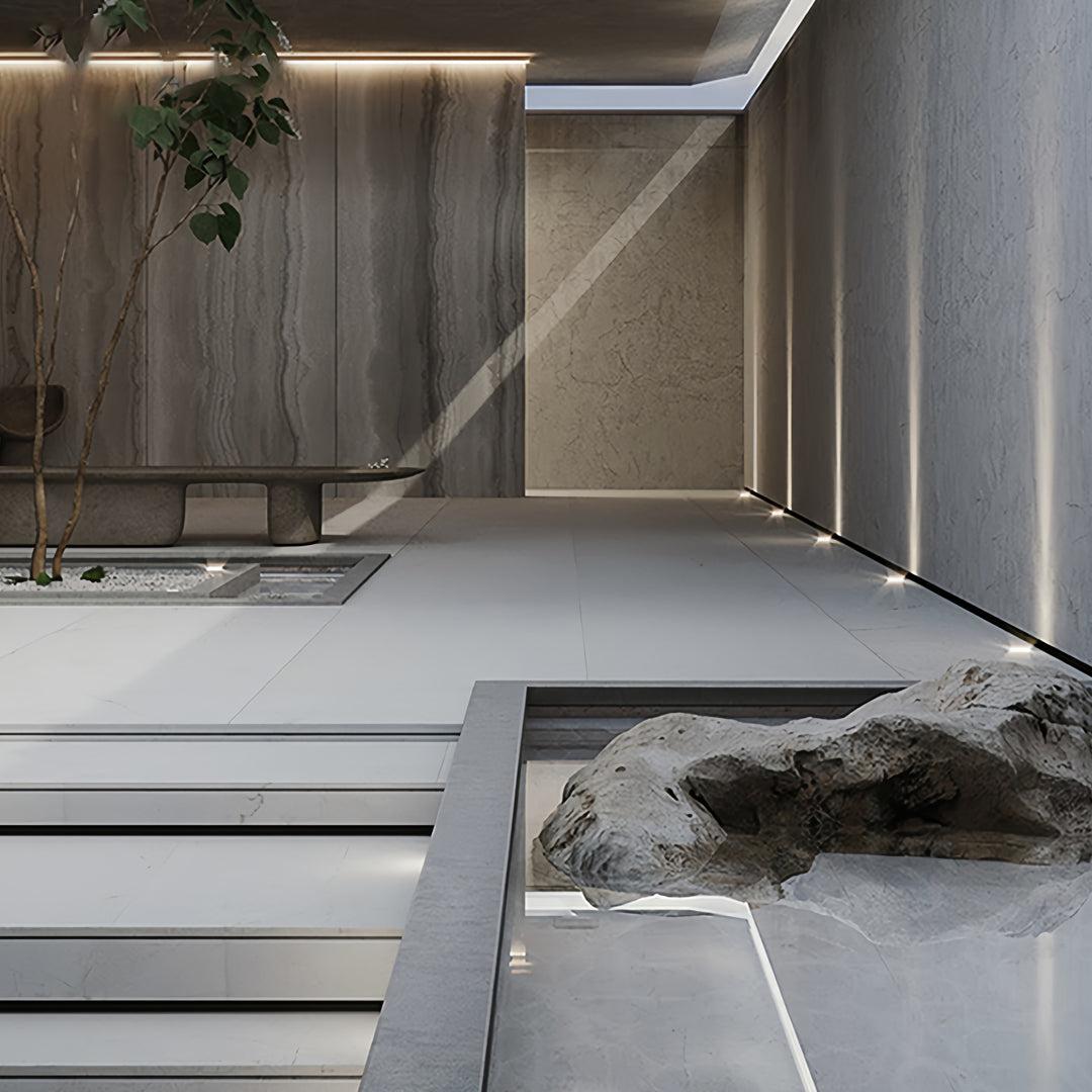 Architectural entrance featuring integrated outdoor inground lighting recessed into stone flooring.