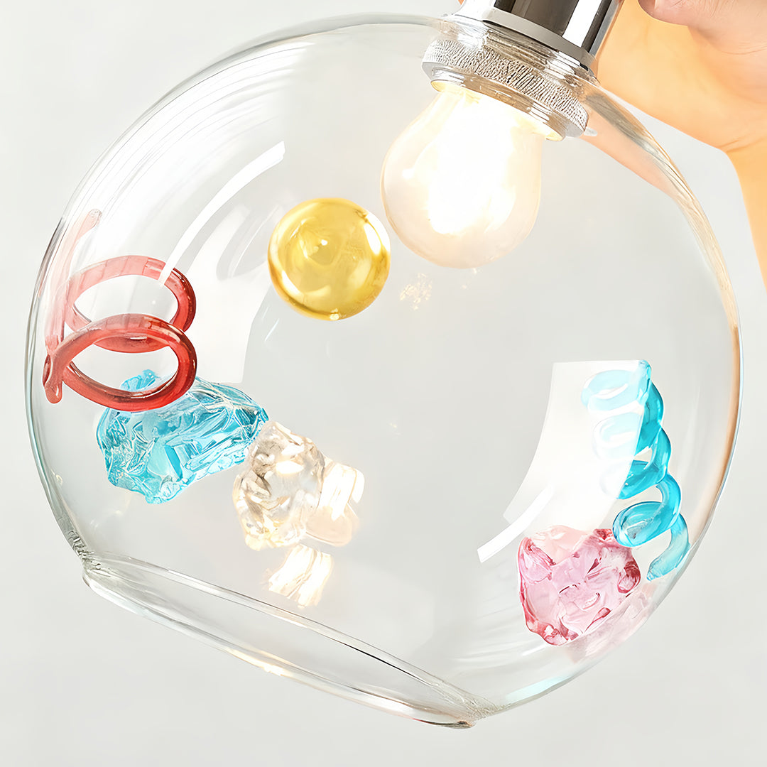 Close-up view of art deco colorful glass pendant lights with metallic and abstract internal art.