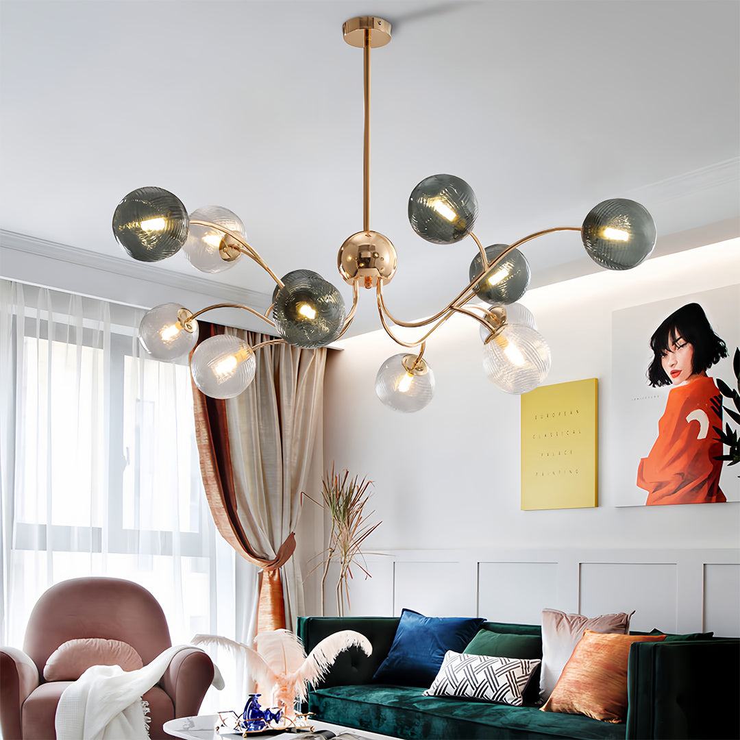 Artistic clear glass flush mount ceiling light fixture with multiple bulbs illuminating a bright, contemporary living space with large windows.