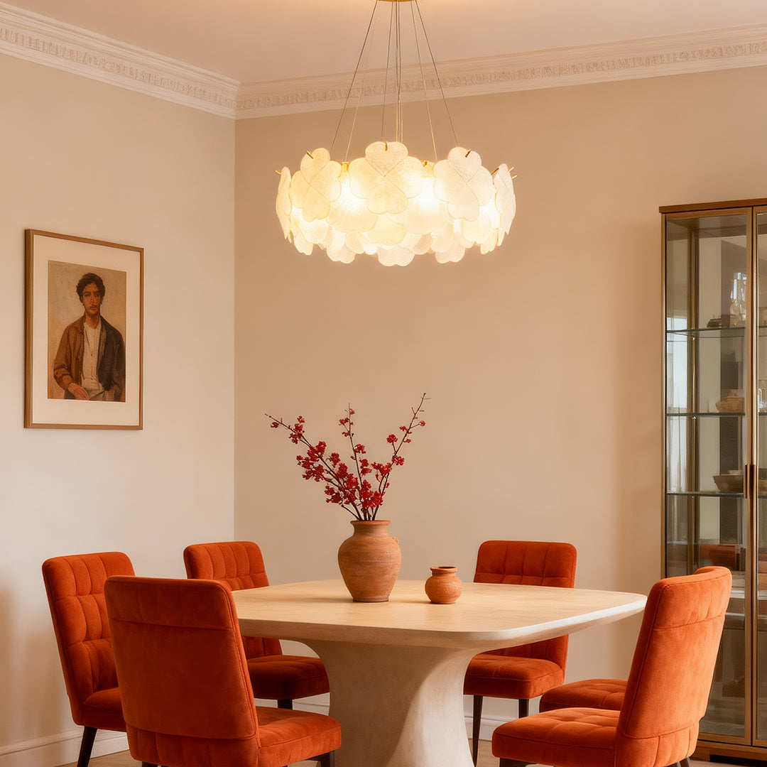 Artistic glass chandeliers installed in a dark-themed living room, providing a striking contrast and warm glow.