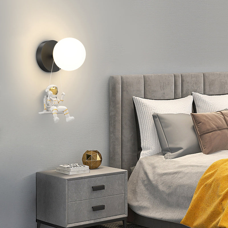 Astronaut wall light adding a playful touch to a contemporary bedroom with neutral tones.