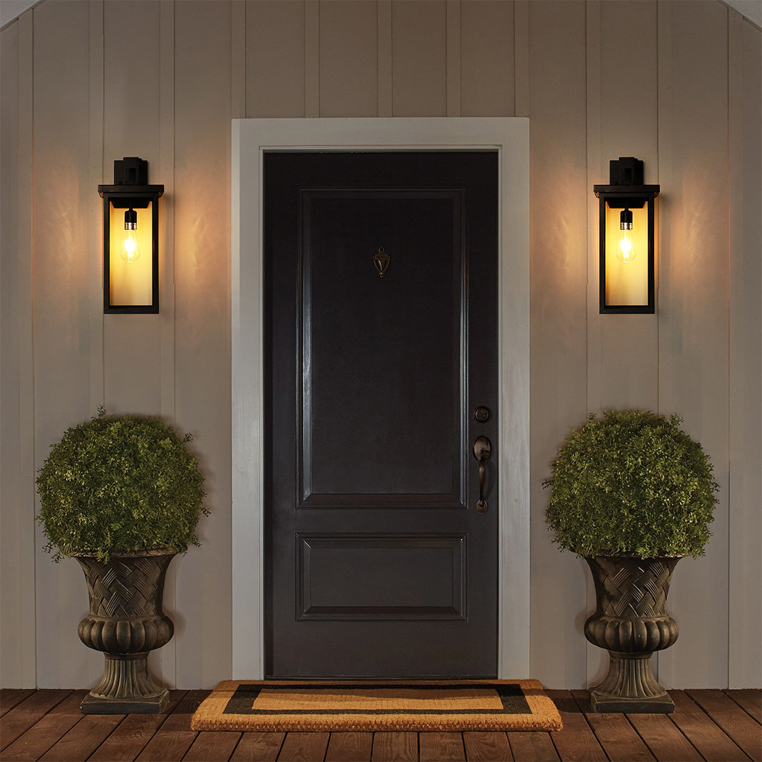 Black exterior lantern wall light with dusk-to-dawn automatic sensor, ensuring energy-efficient and convenient lighting.