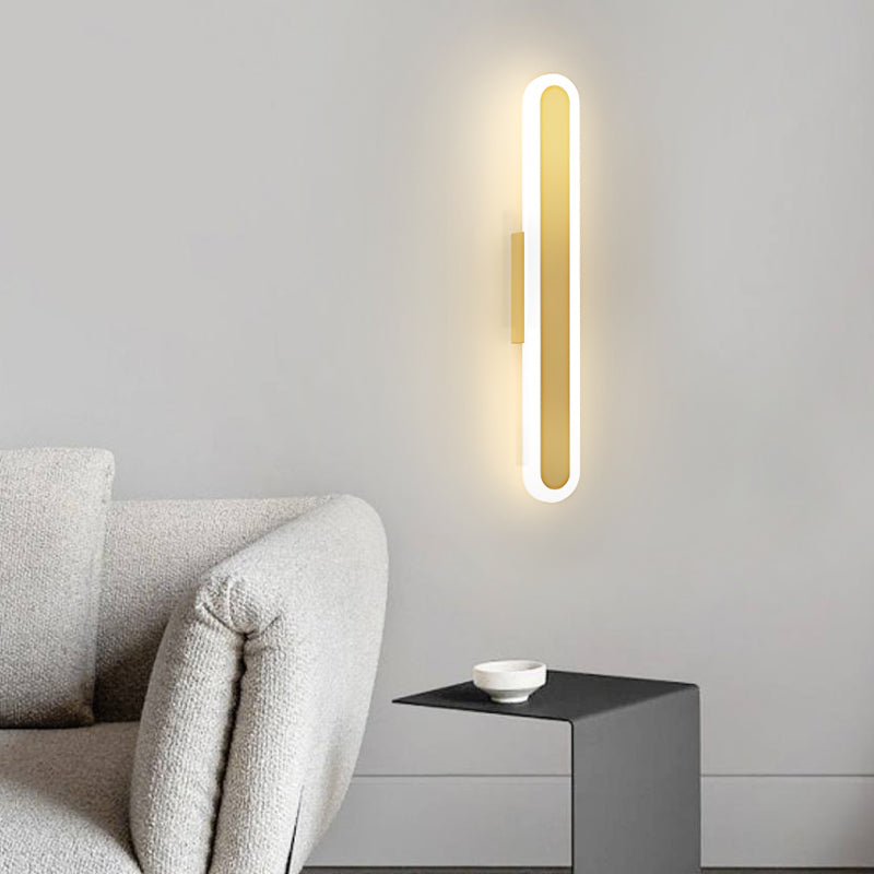 Bar wall light in a hallway, casting a gentle glow on a wooden door.