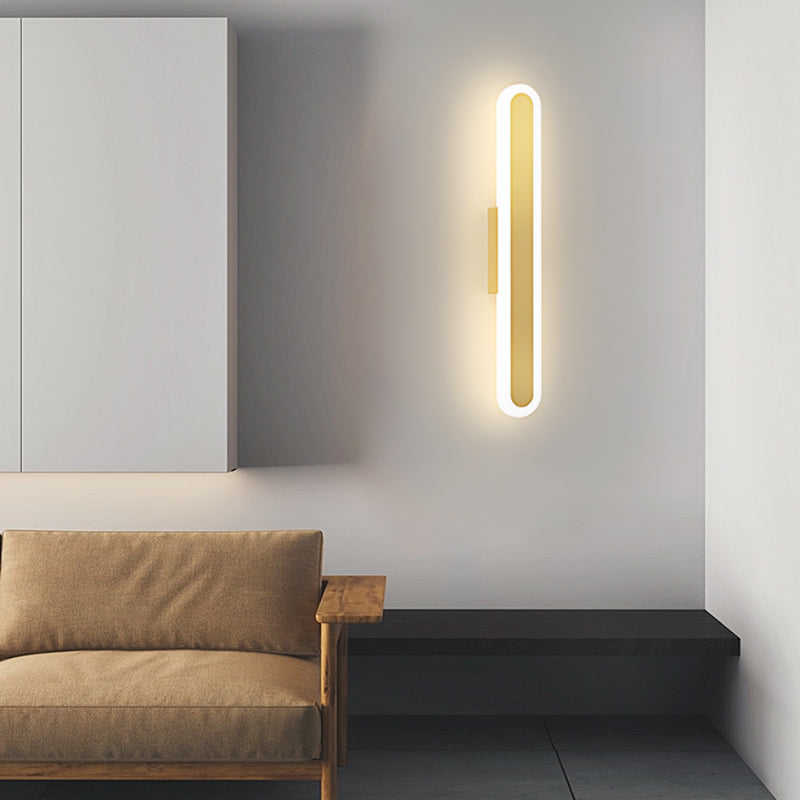 Bar wall light enhancing a minimalist living room with a black sofa and white walls.