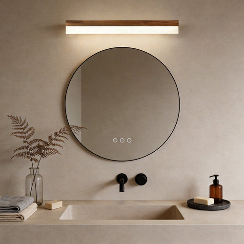 Bath bar vanity light with a sleek design, illuminating a modern round bathroom mirror.