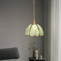 Pale green crystal pendant light hanging elegantly in contemporary bathroom space