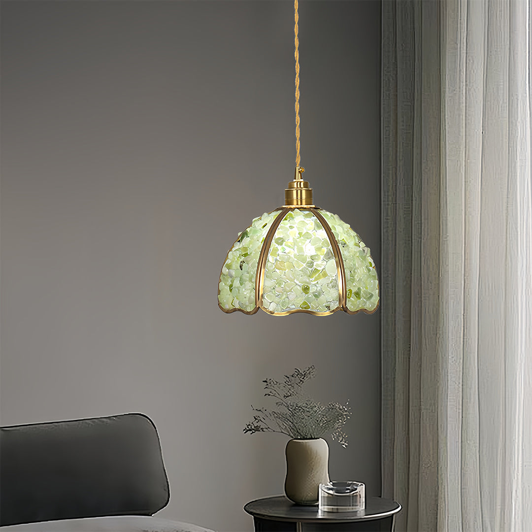 Pale green crystal pendant light hanging elegantly in contemporary bathroom space