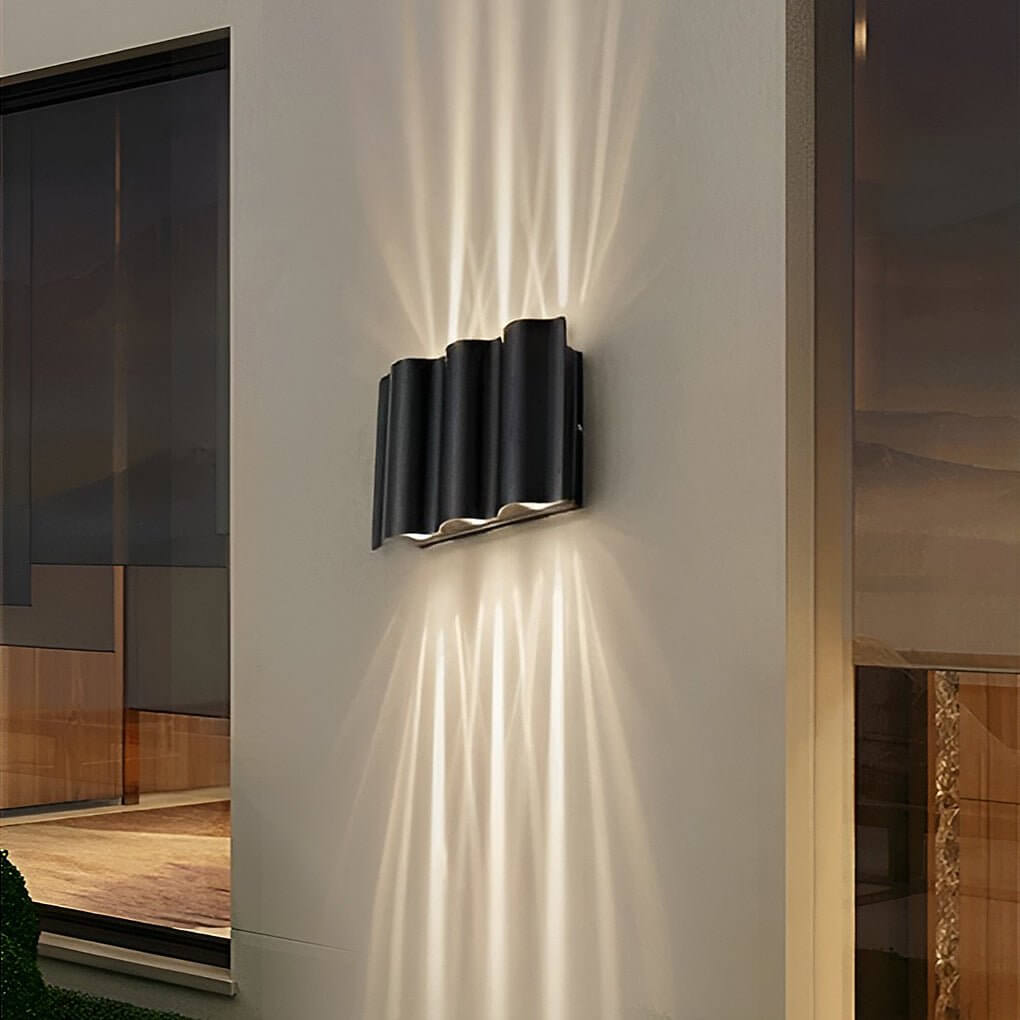 Black beam wall light installed indoors, casting focused light beams on the wall.