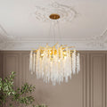 Beautiful modern gold crystal chandelier featuring gold branches and cascading clear crystals.