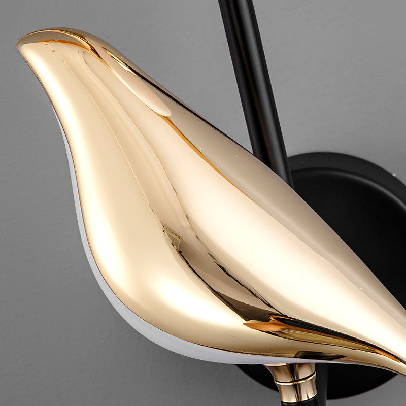 Bird wall light close-up showing metallic bird-shaped lamp body