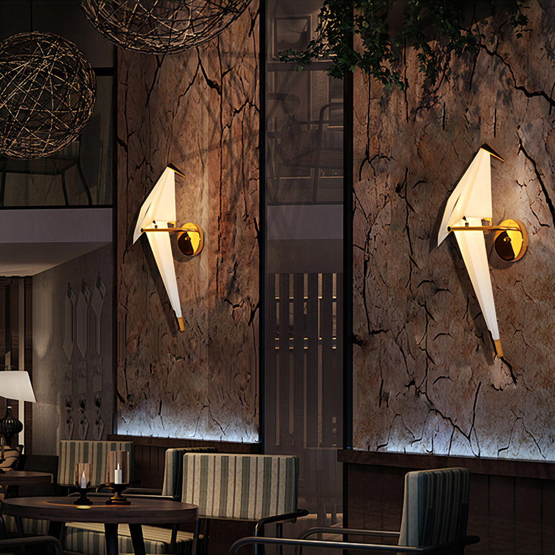 Bird wall light illuminating a modern living room with a gray sofa and coffee table.