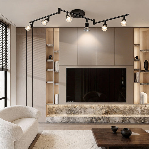 Black adjustable ceiling lights installed in a modern living room, providing flexible spotlight illumination for media walls.