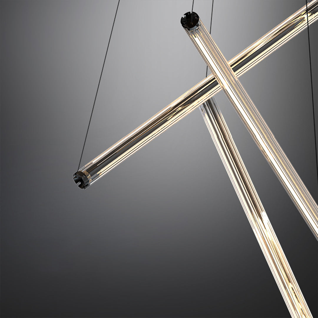 Black background highlighting a LED linear chandelier with gold bars and cables, emphasizing its modern geometric design.