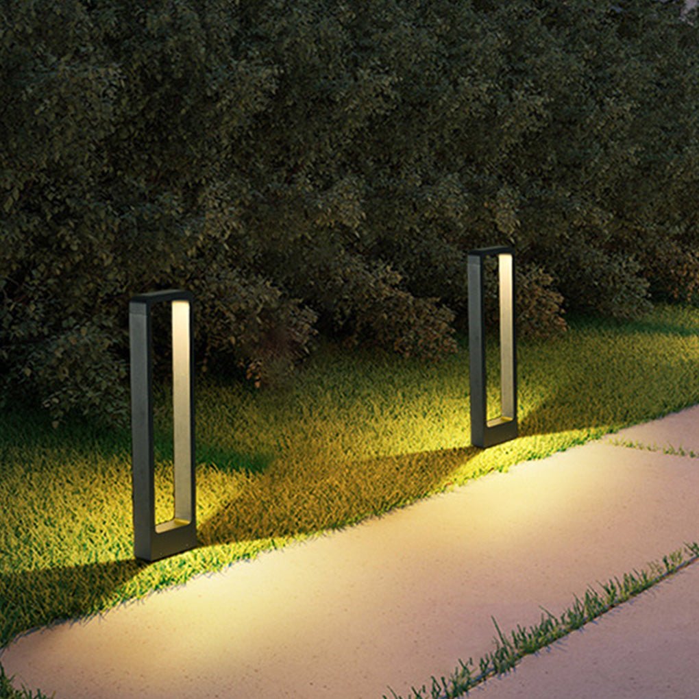 Black bollard lights enhancing a backyard pathway with a warm glow.
