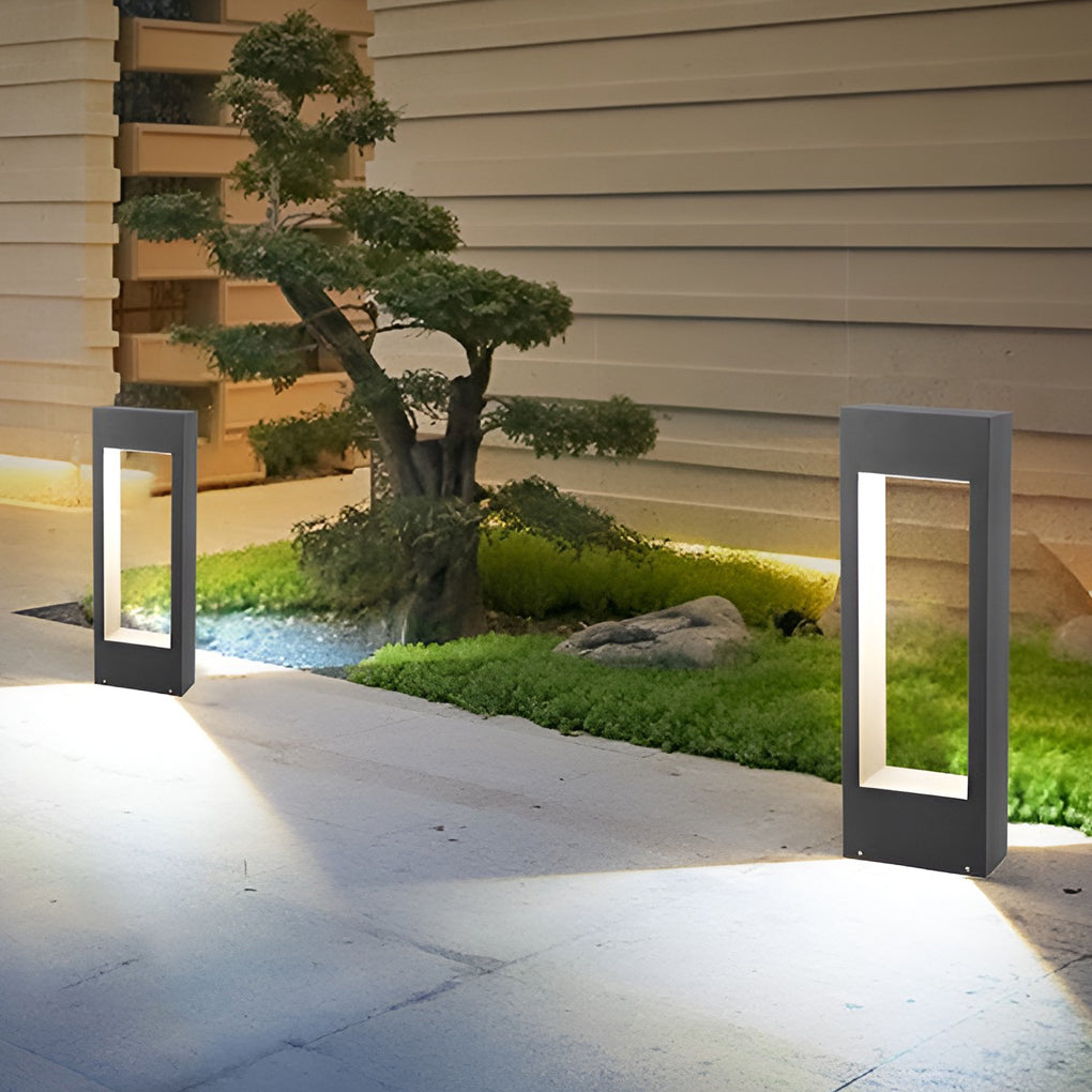 Black bollard lights installed at entrance pathway creating safe night navigation.