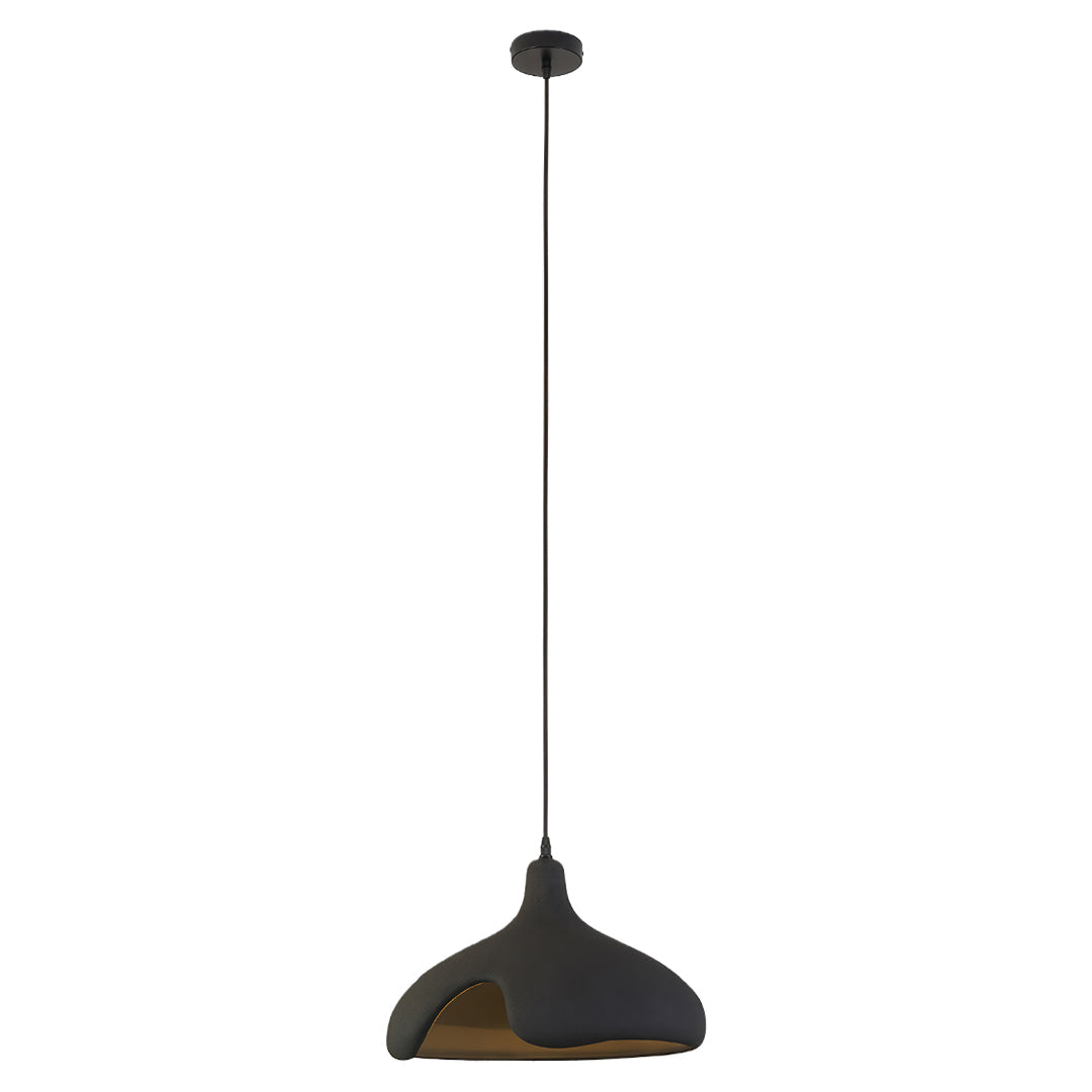 Black cement pendant light with rough industrial texture and warm golden interior.