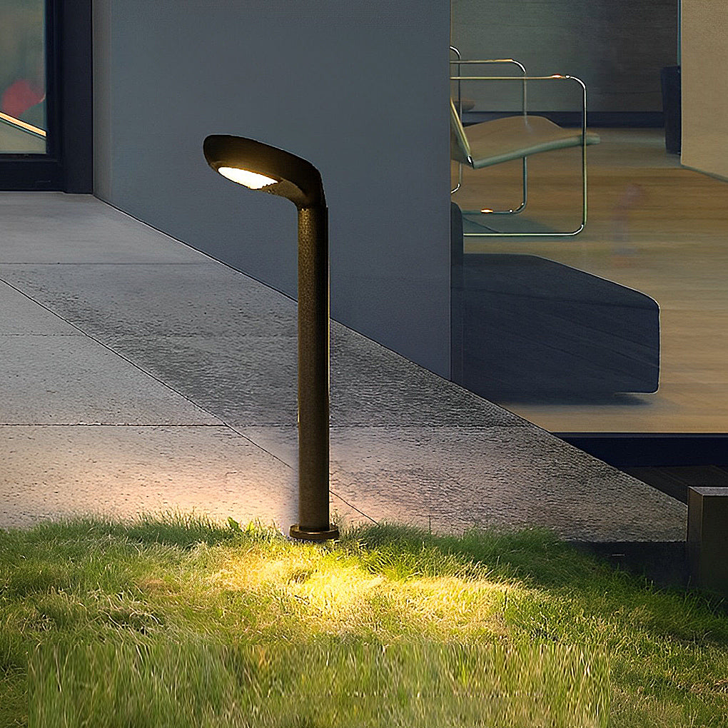 Black curved bollard light installed near outdoor steps and lawn.