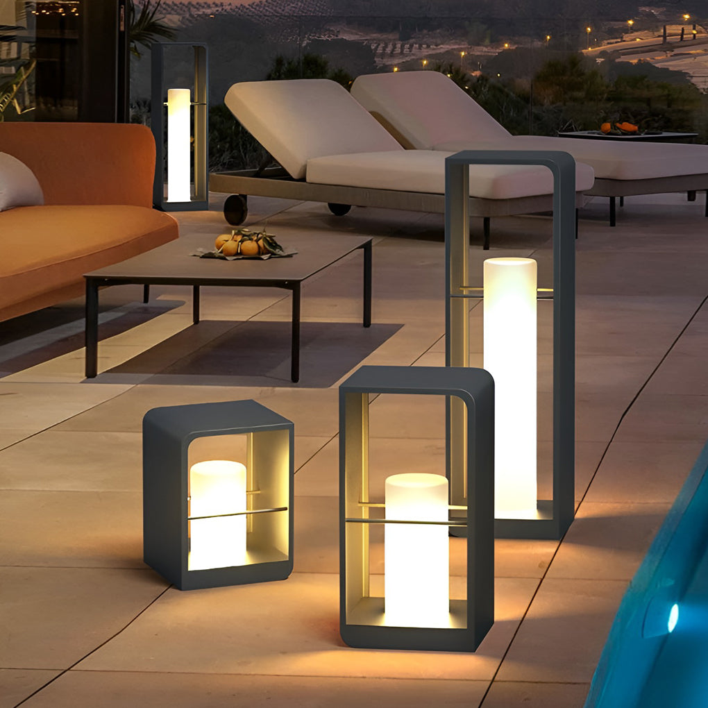 Black lantern outdoor light with contemporary style, illuminating outdoor seating area at night.