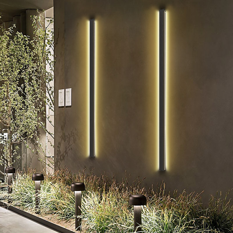 Black linear wall light with a close-up of its sleek black frame and light.
