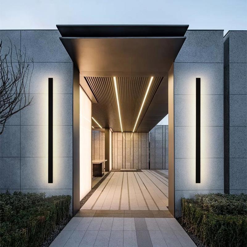 Black linear wall sconce with a close-up of its minimalist design and vertical illumination.