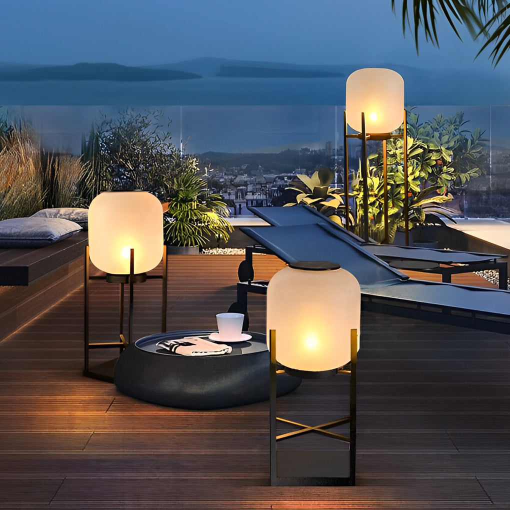 Outdoor standing light with black metal frame and frosted shade on rooftop terrace.