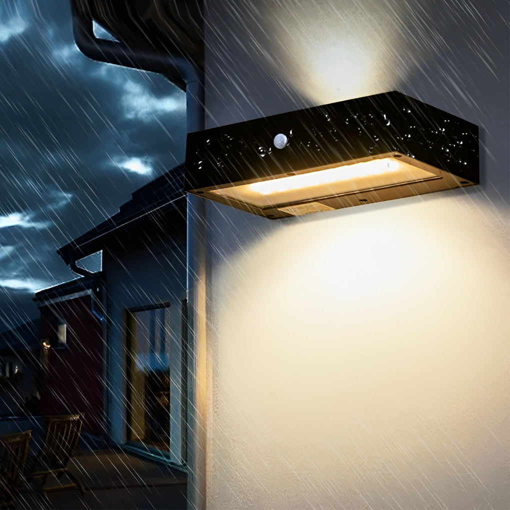 Black motion sensor outdoor wall light providing elegant illumination for a contemporary patio.