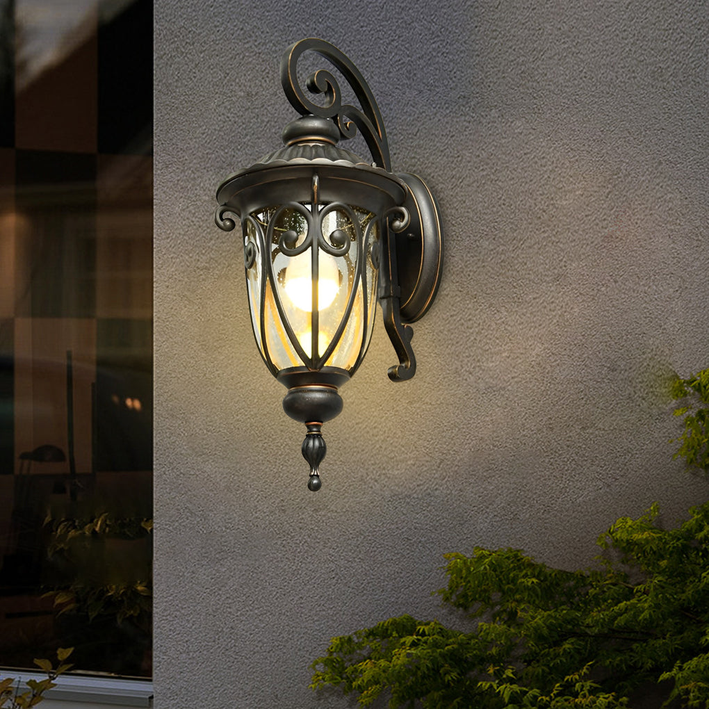 Black outdoor lantern sconce on a white wall, showcasing its intricate design and warm light.
