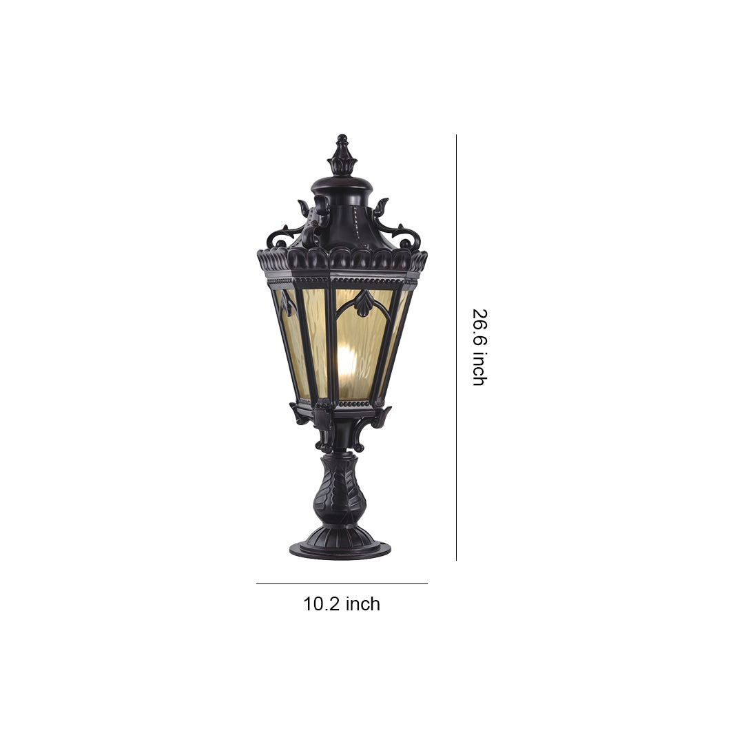 Black outdoor pillar light casting evening glow on grey concrete post near modern home entrance
