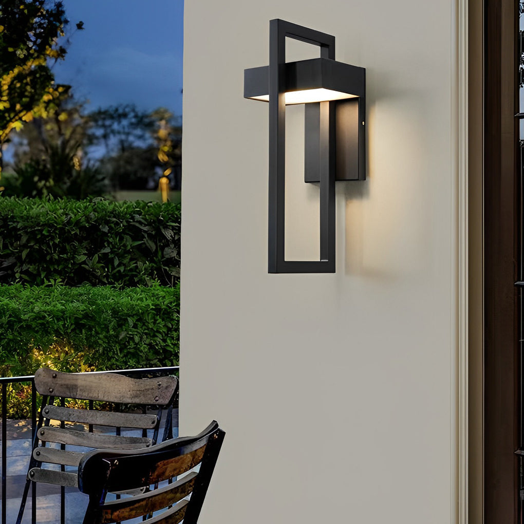 Single black outdoor wall sconce modern illuminating a textured exterior surface at night.