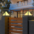 Artistic close-up of outdoor lantern with pyramid diffuser in warm light pillar design.