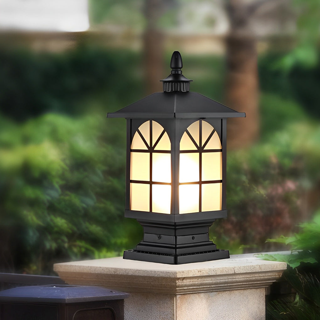 Black street light pillar with arched glass panels on stone column.