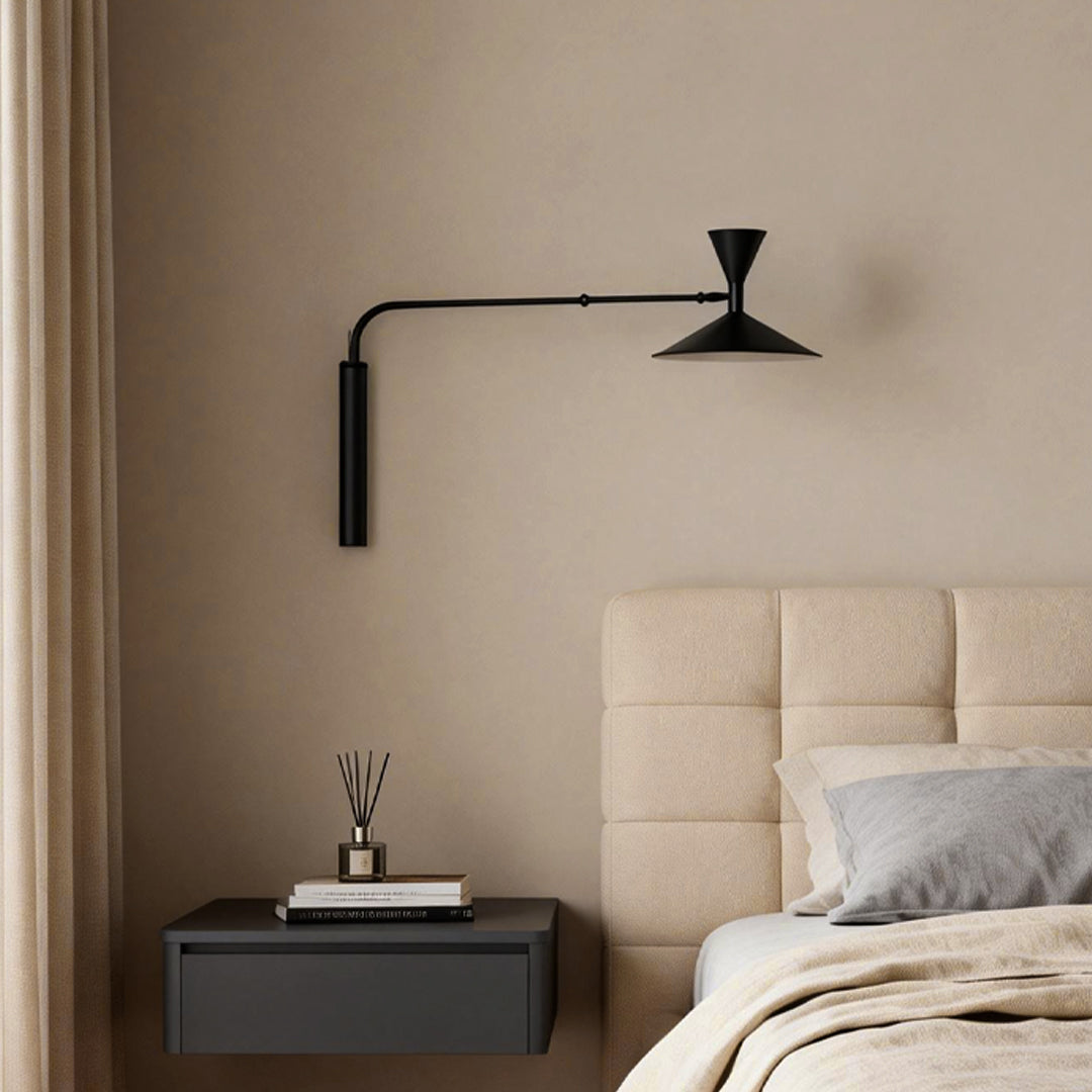 Contemporary swing arm wall sconce with a sleek black finish, ideal for accent lighting in a stylish room setup.