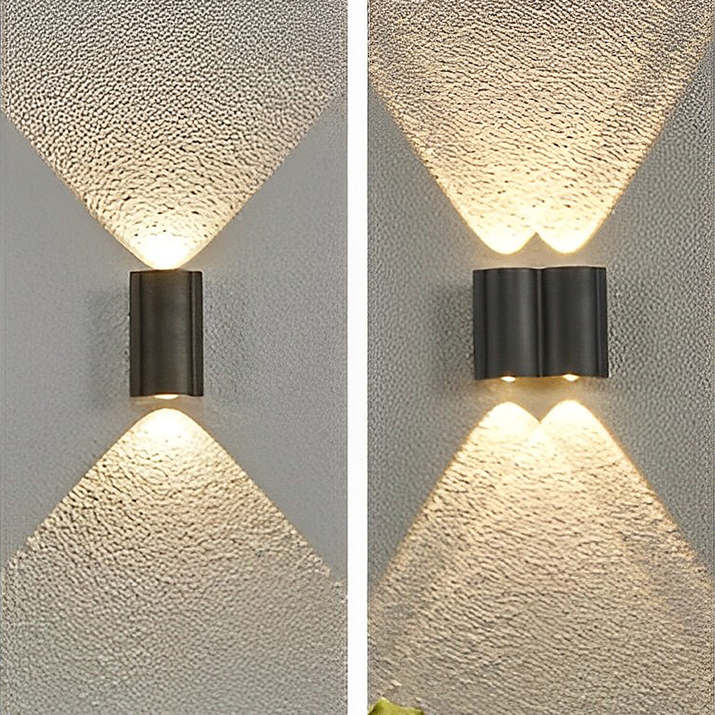Black up and down outdoor wall lights creating elegant lighting effect on textured exterior wall.