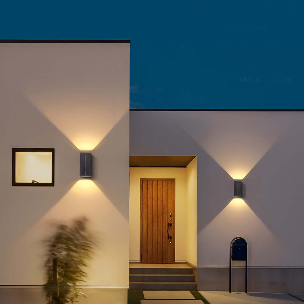 Black up down wall light used beside modern entryway