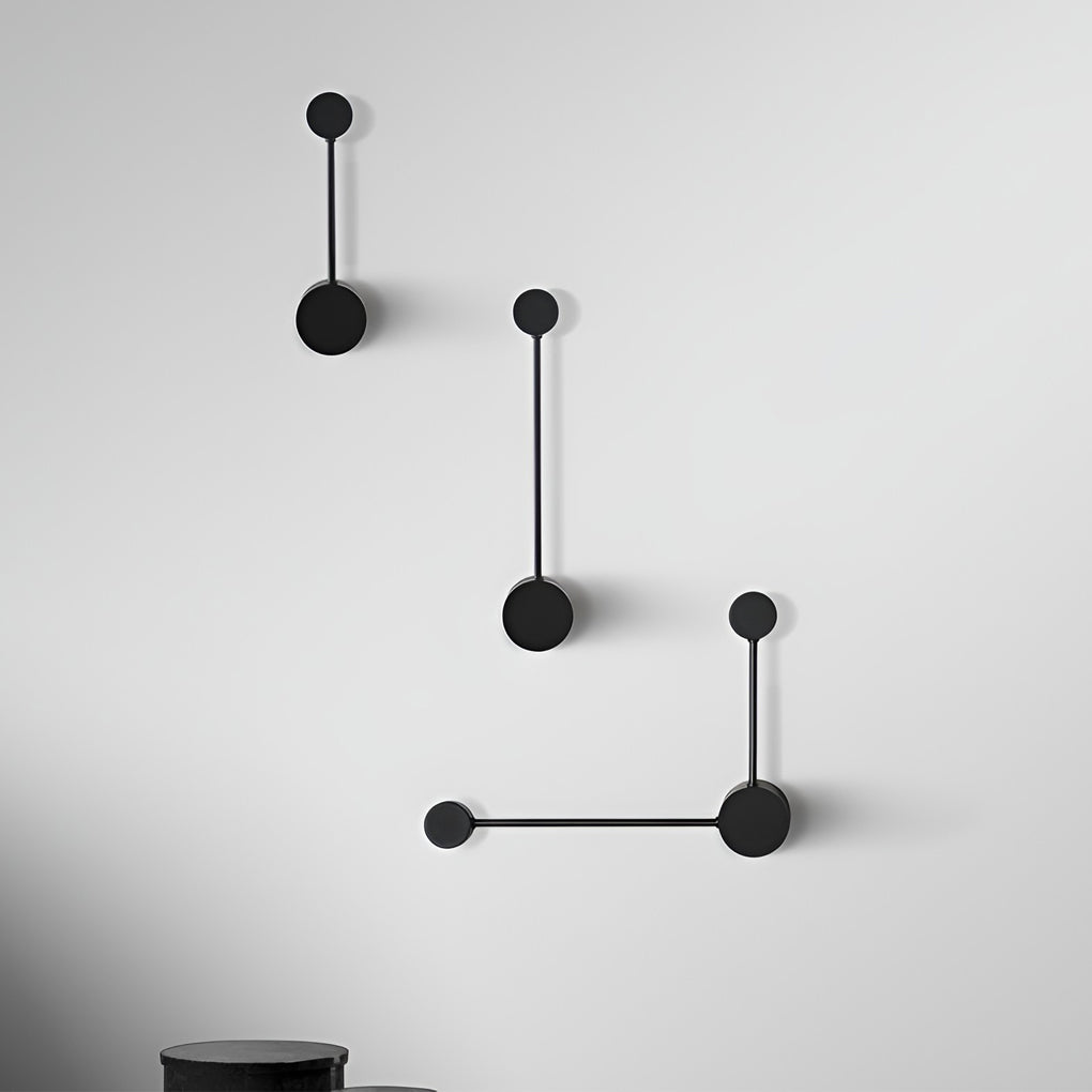 Black wall light enhancing a modern dining area with warm light.