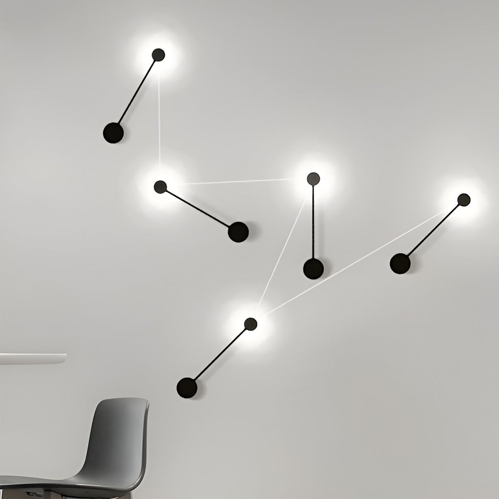 Black wall light illuminating a modern living room with warm directional glow.